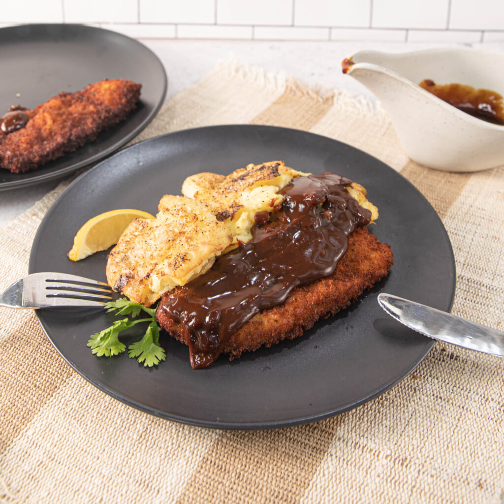 Three Aussie Farmers Schnitzels with Guinness Gravy and Crushed Potatoes